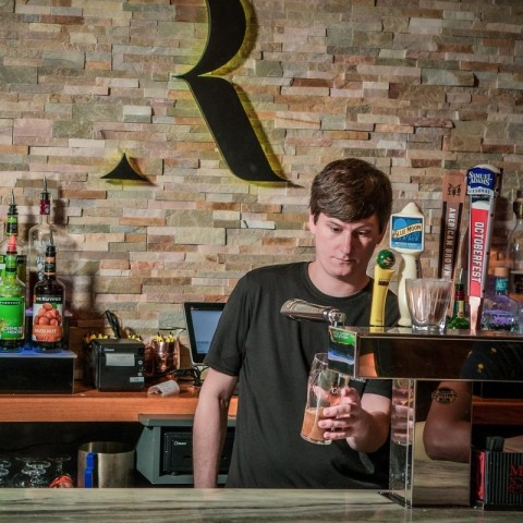 Bartender pouring beer from a tap